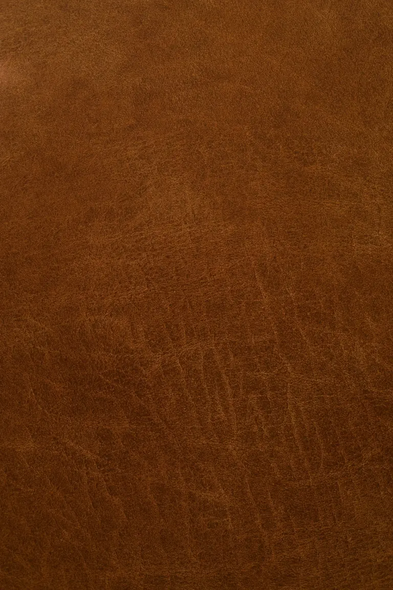 Close-up photograph of warm brown leather grain