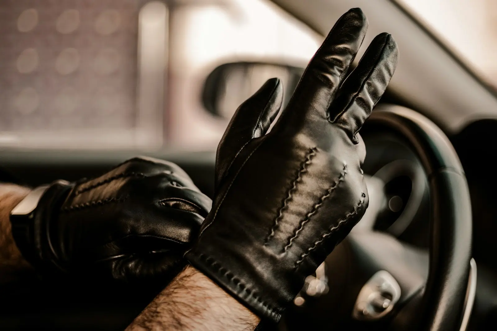 Black leather gloves worn by a driver