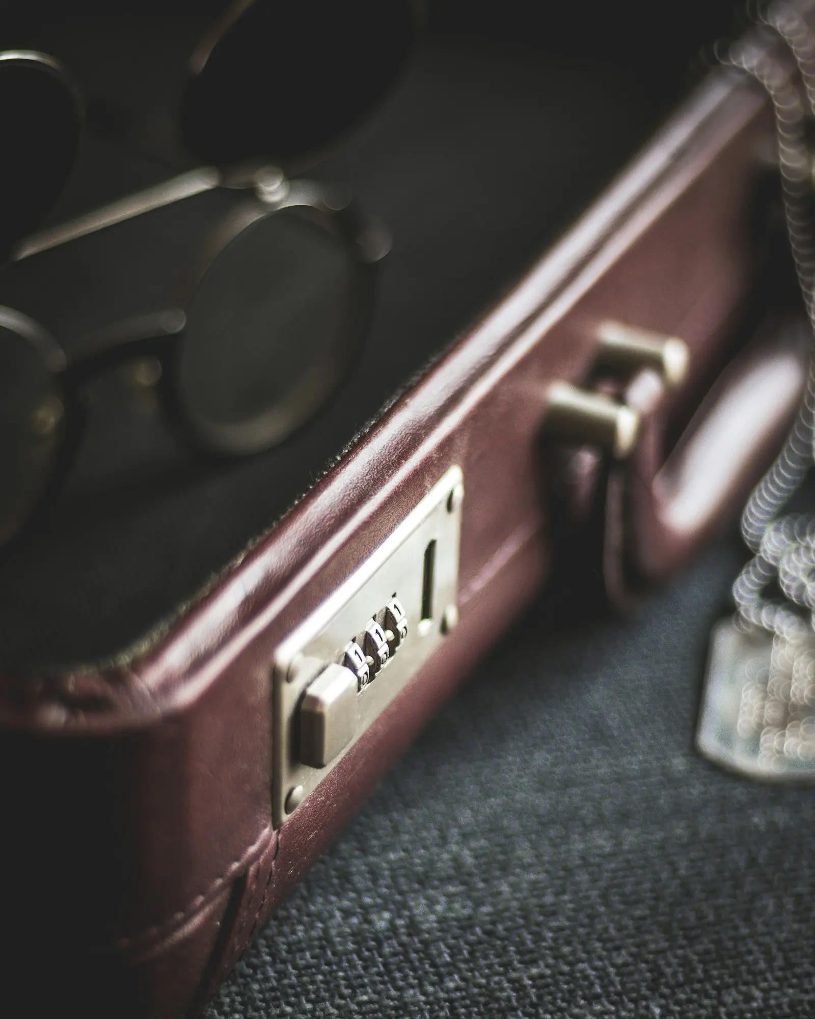 Close view of a brown suitcase handle and combination latch